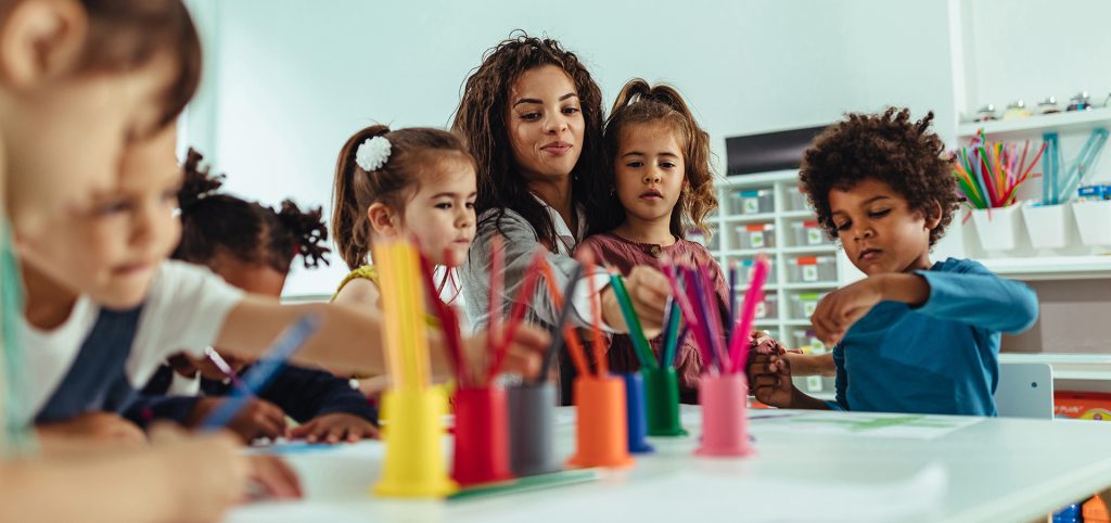 Image of children playing with child care worker