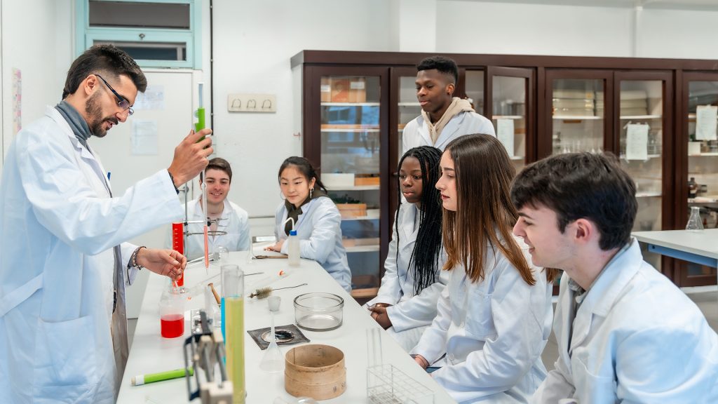Image of a professor and students in a science college classroom