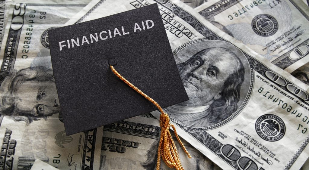 Graduation cap with Financial Aid text, on assorted money