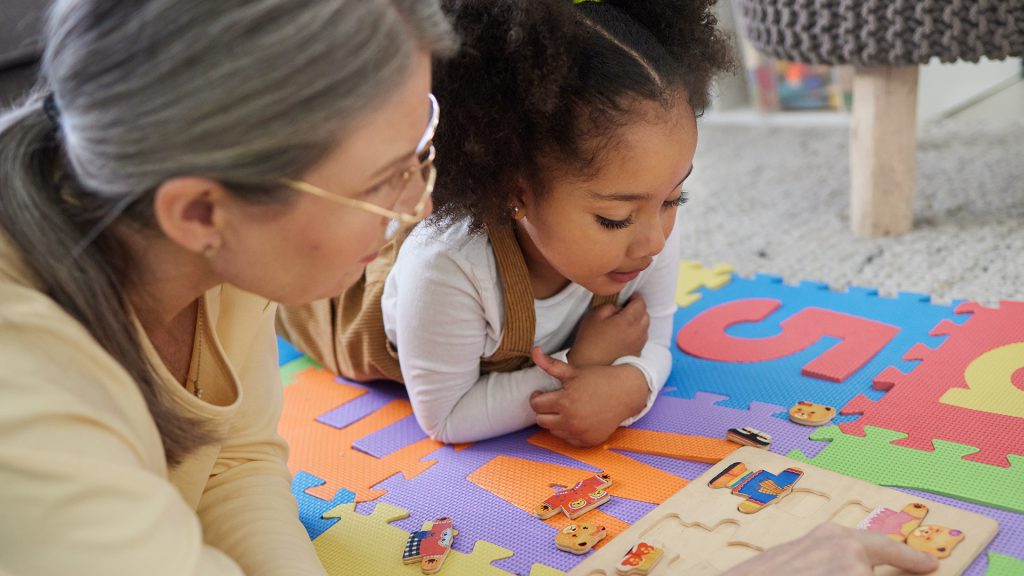 Teacher, therapist and kid with toys for education, learning difficulty or early childhood development. Woman, child or little girl with puzzle for support, tutoring or occupational therapy at home